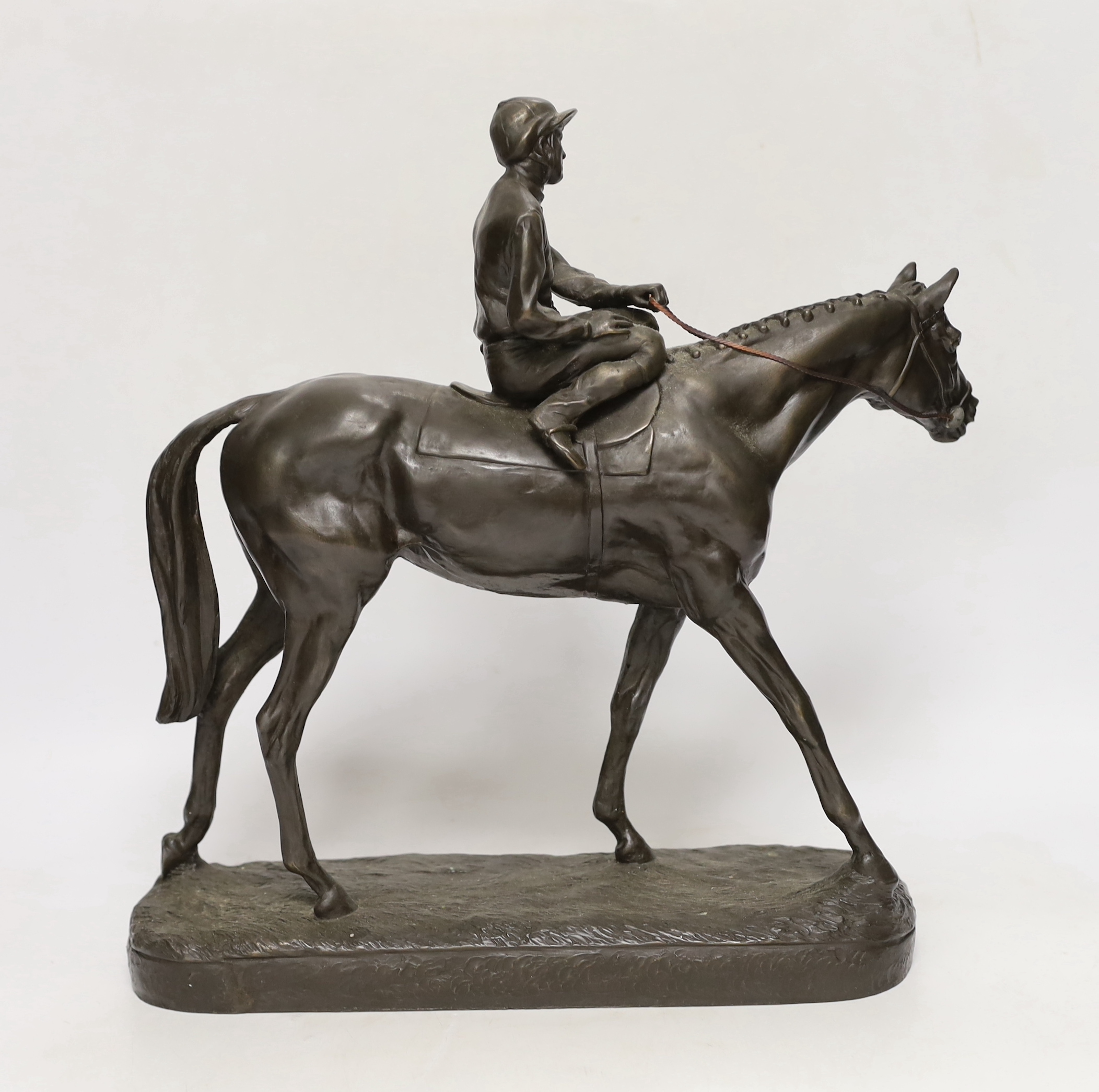 A bronzed resin racehorse and jockey figure group, 33cm high